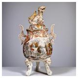 SATSUMA TRIPOD CENSER | Satsuma lidded & footed censer, the lid with a with gilt lion form finial. -