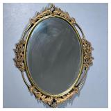 Floral Framed Mirror | Oval mirror in a gilt metal frame with flowers and acanthus leaves. - h. 25 x