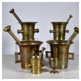 Group Brass Mortar & Pestles | Five mortar and pestle sets, plus a small brass cup.