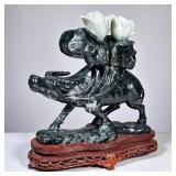CHINESE JADE CARVING OF AN OX WITH BLOSSOMING LOTUS | Jade OR serpentine; a finely carved Chinese st