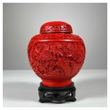 Cinnabar Vase | Carved Chinese cinnabar vase of small size with lid on a carved wood black stand. - 