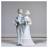 Lladro Bride & Groom Figural Group | Groom holding top hat, arm in arm with bride and her bouquet, m
