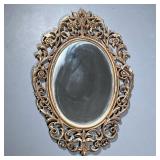 Gold Painted Mirror | Composite ornate framed oval mirror with decorative scrollwork. - h. 34 x w. 2
