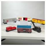 (7pc) LIONEL BOX CARS AND OTHER | Including a Pennsylvania box car, America’s railroad box car; a ye
