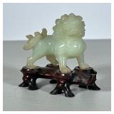 Carved Jade Foo Lion | Chinese carved foo lion figure, accompanied by a conforming wood stand. - h. 