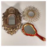 (3pc) Gold Mirrors | One handheld red/gold mirror made in Italy (12 x 6 in.), a heavy gold framed mi