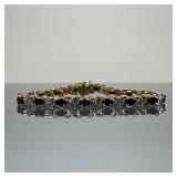 SAPPHIRE & DIAMOND TENNIS BRACELET | Designed as sixteen oval cut sapphires joined by melee diamond-