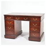 A DIMINUTIVE ENGLISH GEORGE III PEDESTAL WRITING DESK | inset leather top with drawers on one side, 