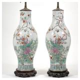 PAIR CHINESE FAMILLE ROSE LAMPS | A pair of porcelain vases with mirrored enameled decoration of bid