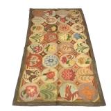 ANTIQUE AMERICAN HOOKED RUG, HILFIGER COLLECTION | Decorated with figures within circular reserves -