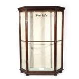 "BEST & CO. GLASS ANTIQUE DISPLAY CABINET | having a single glass door flanked by two glass panels h