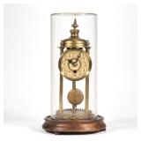 "GLASS DOME & BRASS CLOCK | Skeleton mantel clock on wood base with glass dome h. 14.5 x dia. 8 in."