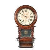 "COCA-COLA WALL CLOCK | In a carved wood case with mirror behind pendulum, the face with Roman numer