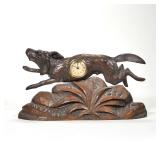 "BLACK FOREST CARVED HUNTING DOG-FORM CLOCK | Depicting a dog leaping over a carved plant, his body 
