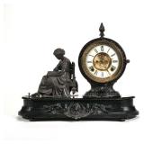 "ANSONIA CLOCK CO. FIGURAL MANTEL CLOCK | Having cast metal figure of woman reading h. 14 x l. 17 x 