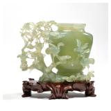 "RETICULATED CARVED JADE VESSEL | On a conforming carved wood stand h. 5.5 x w. 3 x l. 7 in. (Jade o