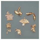 "(8pc) GROUP OF 14K GOLD CHARMS | Including a sailboat (marked 14k); an articulating cuckoo clock (n