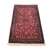 RED SCULPTED PERSIAN RUG | 20th century, red field and dark red and blue border - w. 36 x l. 64 in.