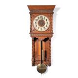 "CARVED OAK WALL CLOCK | With pressed brass face and pendulum, with barley twist turnings h. 36 x w.