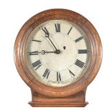 "OAK CASED REGULATOR CLOCK | Old paper face with Roman numeral markers h. 34 x w. 16 x d. 5.5 in."