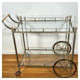 Brass Bar Cart | Hollywood Regency style silvered brass drinks cart with acorn finials, with two gla