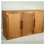 MID CENTURY THREE DOOR CREDENZA CABINET | Light wood with 3 doors and one shelf. Doors have rattan-l
