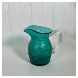 Small Green Glass Pitcher | Glass green textured patterned pitcher marked "MMA" with clear glass han