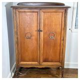 Small Armoire with Carved Details | Vintage armoire on caster wheels, with detailed carvings on the 