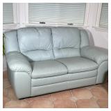 Pale Green Leather Loveseat | Pale green colored, two cushioned leather loveseat. Seat depth: d. 21 