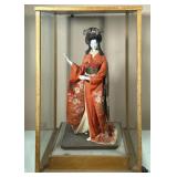 Geisha Doll | Porcelain statue with traditional kimono attire and wig in display case. Possibly a Ni