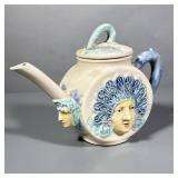Unique Pitcher | Woman with blue handle and blue headwear. Marked on the bottom. - h. 7 x w. 9 in