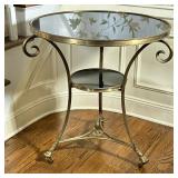 Gueridon Side TABLE | Having black stone top and matching lower tier; brass round table with claw fe