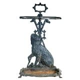 CAST IRON UMBRELLA STAND | Umbrella or cane stand decorated with a seated terrier dog and crossed wa