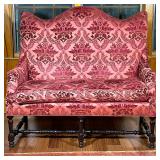 Damask Settee/Loveseat | Tall curved back loveseat in tones of red/cranberry. Dark carved wood stret