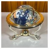 Table Top Globe | Black globe spins and tilts. Stand is gold colored plastic. - h. 9 x dia. 9 in