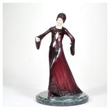 After Chiparus Painted Bronze | Woman in red dress Bone and red-painted bronze on a green marble bas