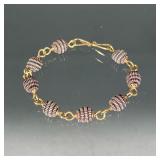 18k YELLOW GOLD & STERLING SILVER BRACELET | Designed as eight stations of silver beads connected by