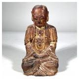 GILT CARVED BUDDHA STATUE | Gilt and lacquered wood carved figure of Buddha or a boddhisattva seated