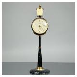 KAISER LAMP POST CLOCK | German, designed as a lamp post, having a silvered dial with abstract and R