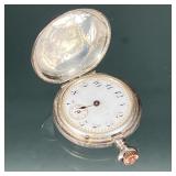 Narcisse Sterling Pocket Watch | A sterling silver Narcisse pocket watch with Arabic numerals on a w