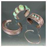 (4pc) TURQUOISE HARD BRACELETS | A group of silver tone cuff bracelets, including a Navajo-style cuf