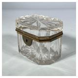 CRYSTAL TRINKET BOX | Clear-cut crystal with a hinged lid, having a gilt brass frame around the hing