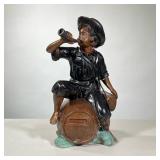 BRONZE DRINKING BOY STATUE | Painted bronze statue of boy drinking on top of keg, with incised signa