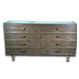 MODERN HISTORY LINEAR DRESSER | Having 6 drawers with rectangular brass pulls raised on bronze feet 