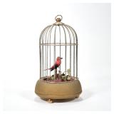 GERMAN MUSICAL BIRD AUTOMATON | Designed as a red and black feathered bird within a brass cage on th