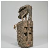 Carved African Mask | Carved wood & painted African mask crested by a bird with rope net backing Dim