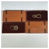 (2pc) [NIB] VINTAGE GUCCI KEYCHAINS | Two vintage Gucci keychains in gold-tone metal, each in origin