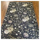 Area Rug - White Floral on Dark Green | Vintage area rug with white floral details on a dark green/b