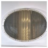 Art Deco Style Oval-Shaped Wall Mirror | Art Deco style, oval-shaped wall mirror with a metallic fra