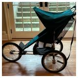 Baby Jogger Jogging Stroller | Baby Jogger jogging stroller on three wheels, with green canopy and s